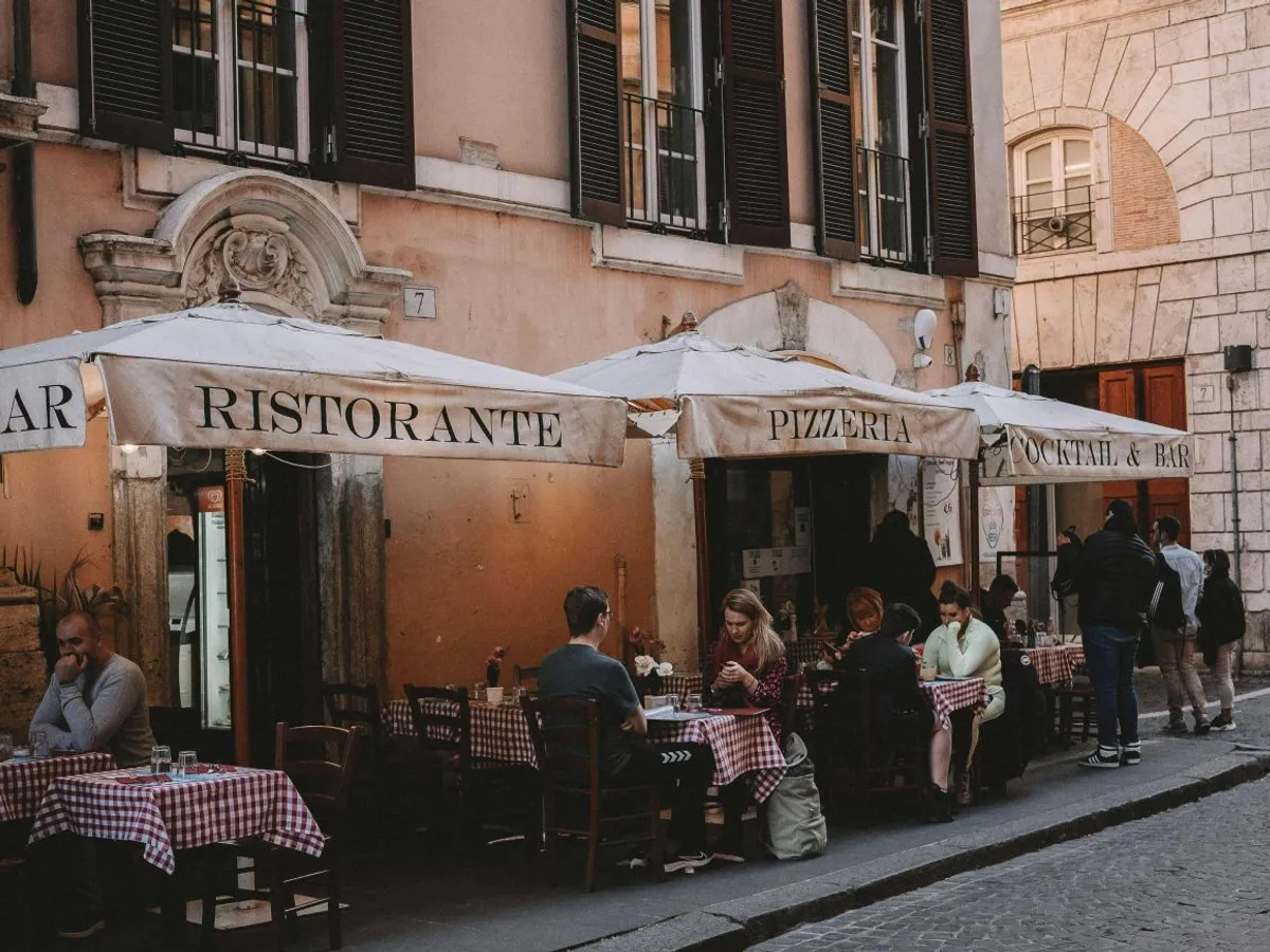 Clienţi stând la masă, la o terasă, la un restaurant din Italia - Foto: Pexels/Gonzalo Mendiola