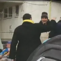 George Simion în momentul în care întinde mâna să-i de una peste ceafă unui botoșănean care nu a vrut să dea mâna cu el Foto: captură Botosaneanul.ro