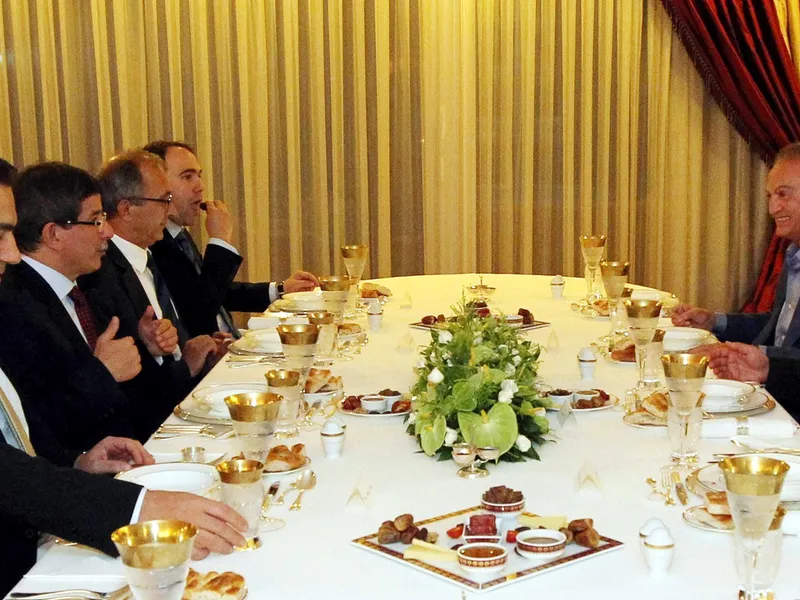 Ministrul de Externe al Turciei, Ahmet Davutoglu (al doilea din stânga) și oficiali turci participă la o cină de Ramadan cu generalul sirian Manaf Tlass, în 2012 - Foto: Profimedia Images