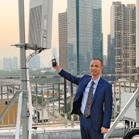 Un angajat al China Telecom compară o stație 4G, dreapta, cu versiunea 5G. Rețelele 5G pot suporta o cantitate mult mai mare de date