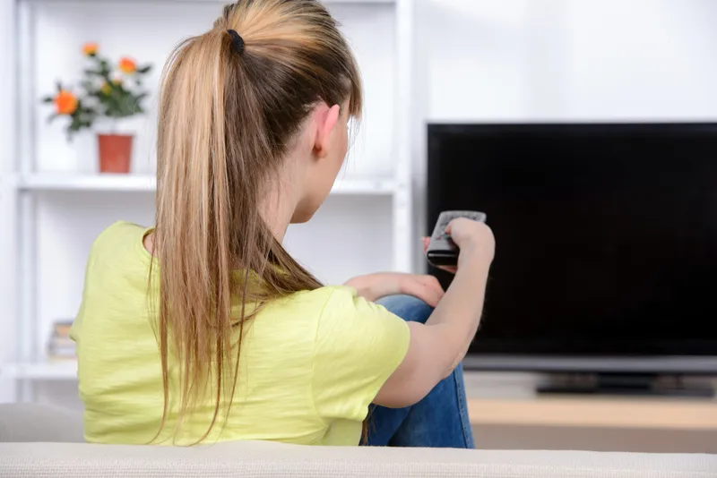 Femeie care se uită la TV - Foto: Magnific.com (Imagine cu rol ilustrativ)