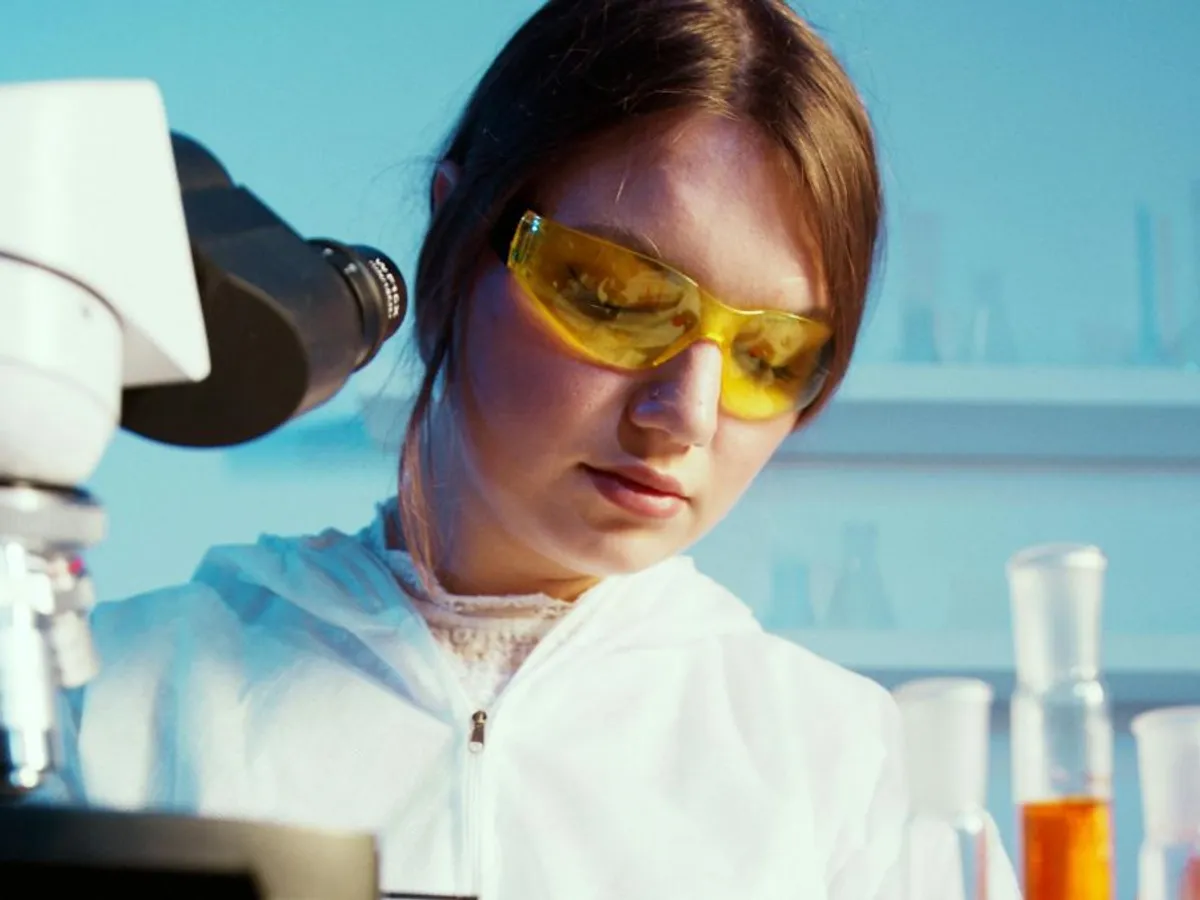 Cercetător analizând o probă la microscop - Foto: Pexels/Artem Podrez