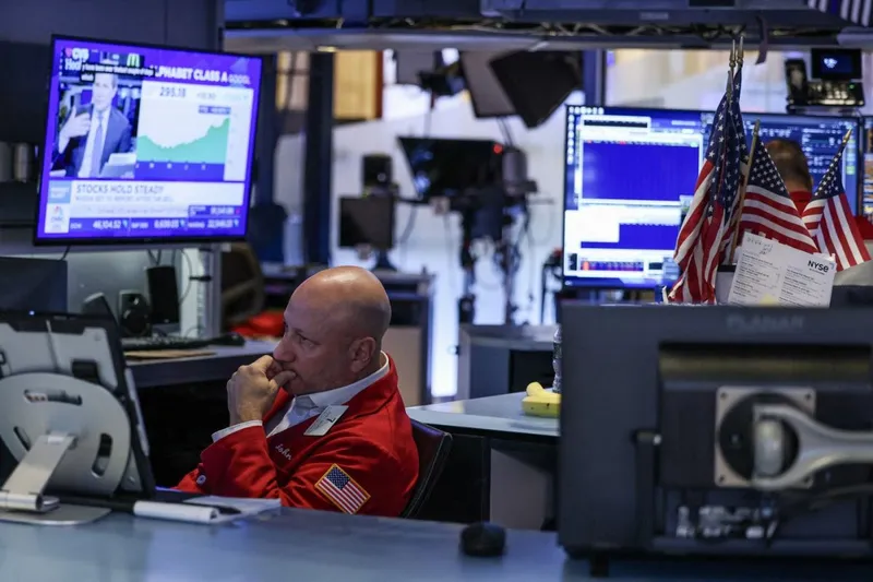 Un trader de la New York Stock Exchange urmăreşte ce se întâmplă cu acţiunile - Foto: Profimedia Images