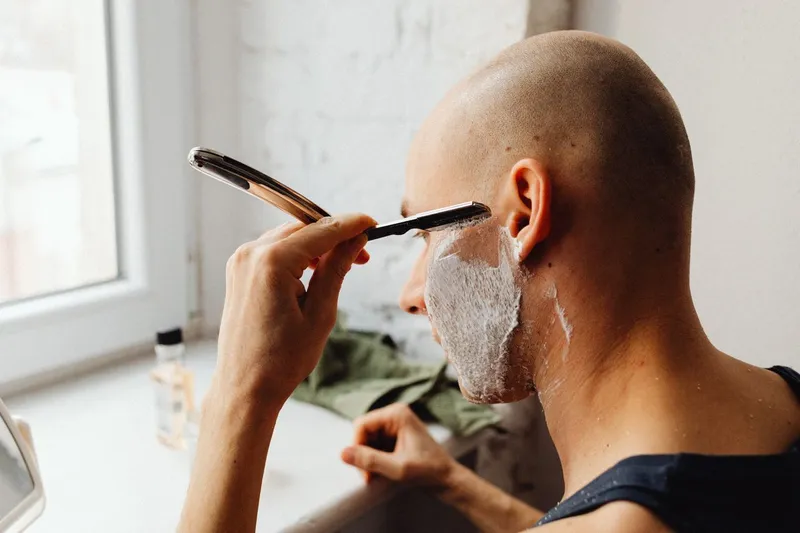 Bărbat adult care se rade cu un aparat de ras - Foto: Pexels (Imagine cu rol ilustrativ)