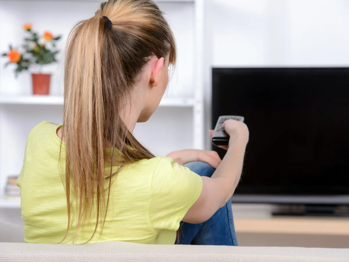 Femeie care se uită la TV - Foto: Magnific.com (Imagine cu rol ilustrativ)