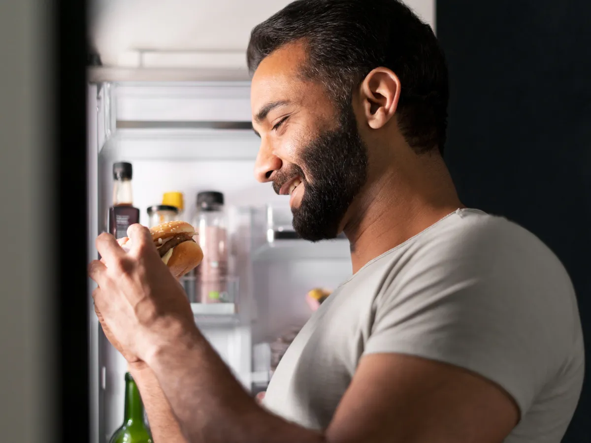 Bărbat care mămâncă din frigider - Foto: Freepik (Imagine cu rol ilustrativ)