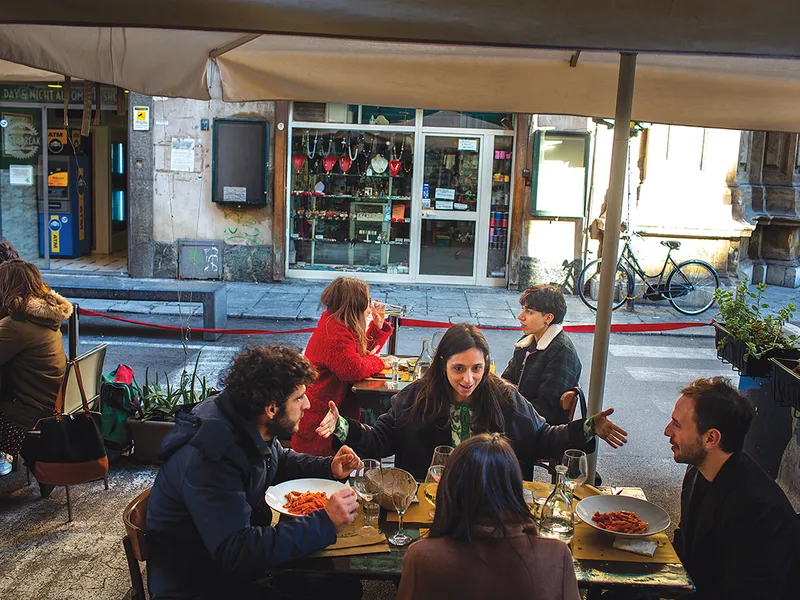 Clienți pe terasa unui restaurant din Palermo.