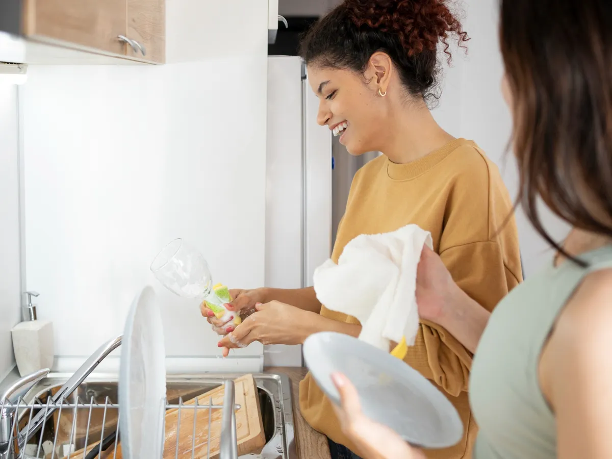 Femeie la mașină de spălat vase - Foto: Freepik