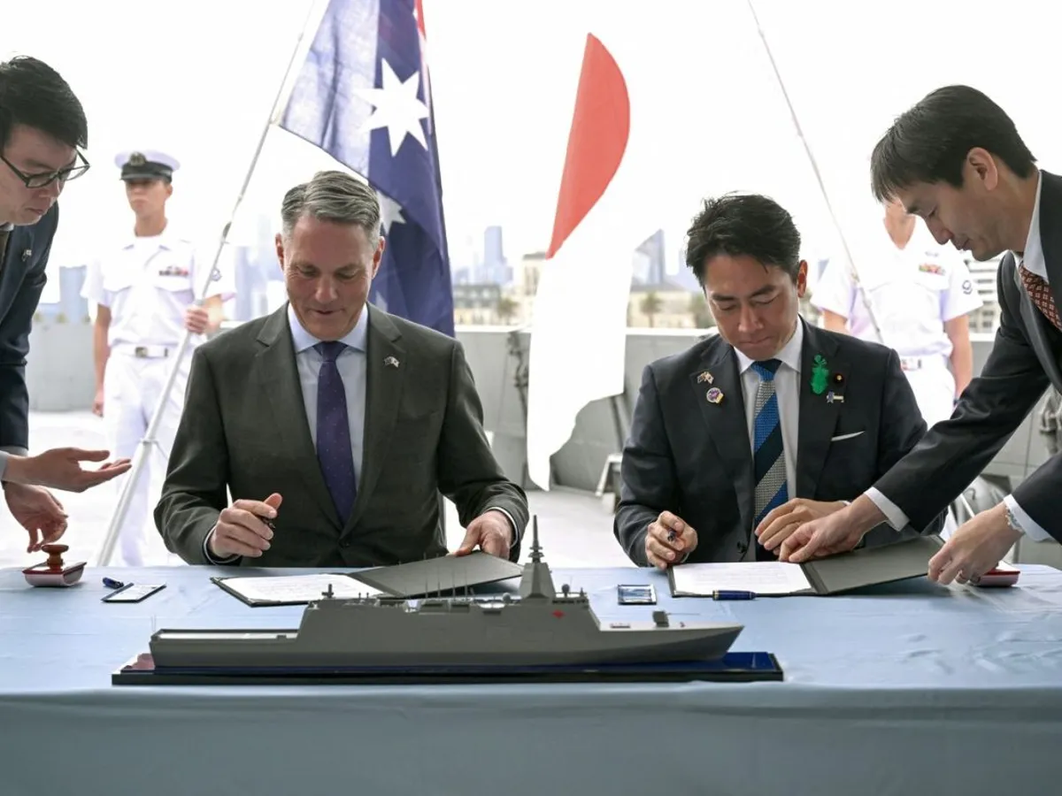 Ministrul Apărării austrialian, Richard Marles, şi omologul său japonez, Koizumi Shinjiro, semnează contractul pentru cele trei fregate - Foto: Profimedia Images