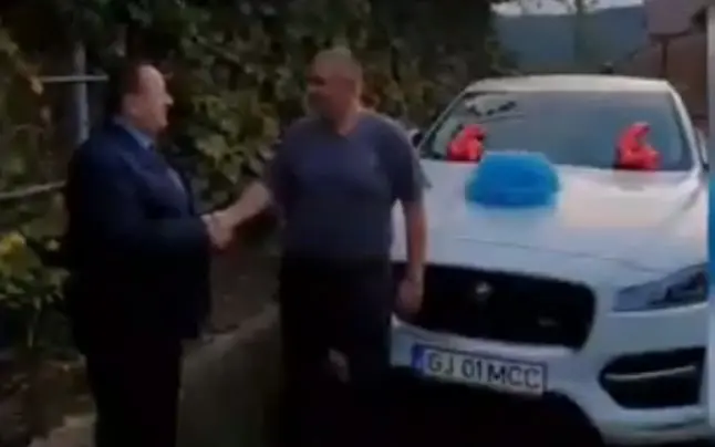 Unchiul Morega, PNL, îl felicită pe nepoțelul Morega, PSD. La mijloc, un Jaguar, neutru. Foto: Captură video