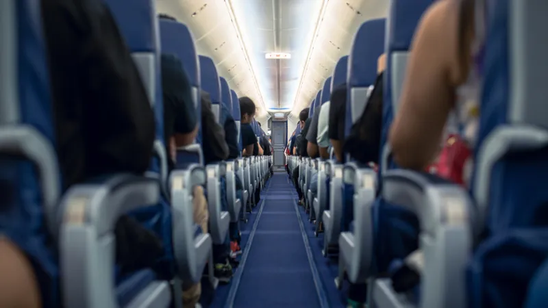 Motivul pentru care o pasageră a fost dată afară din avion. Se juca pe telefon când a venit poliția - Foto: Istock / imagine cu rol ilustrativ