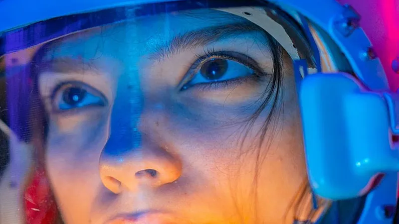 Femeie în combinezon de cosmonaut uitându-se la stele - Foto: Pexels/Mikhail Nilov