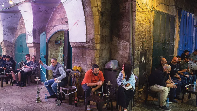 Oameni care savurează o narghilea, cu ceai sau cafea după ce se roagă seara în timpul Ramadanului la Ierusalim
