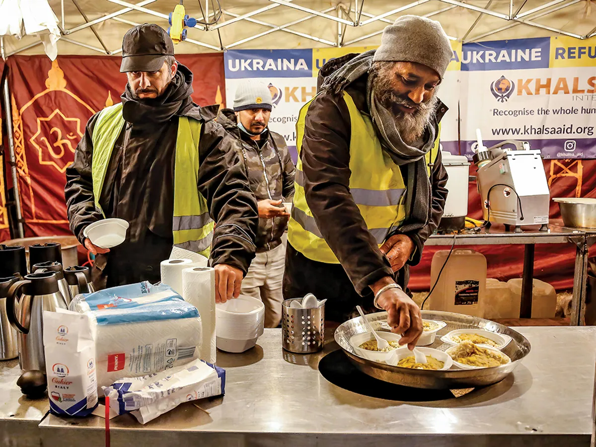 Voluntarii oferă băuturi și gustări într-o tabără temporară pentru refugiații ucraineni din Przemisl, Polonia