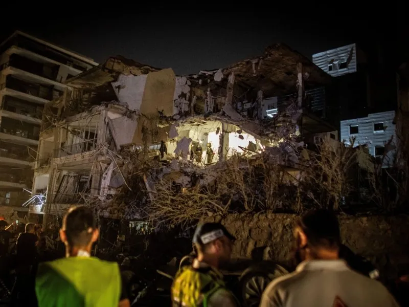 Soldați ai comandamentului frontului intern israelian lângă o clădire lovită de o rachetă balistică iraniană în Ramat Gan - Foto: Profimedia Images
