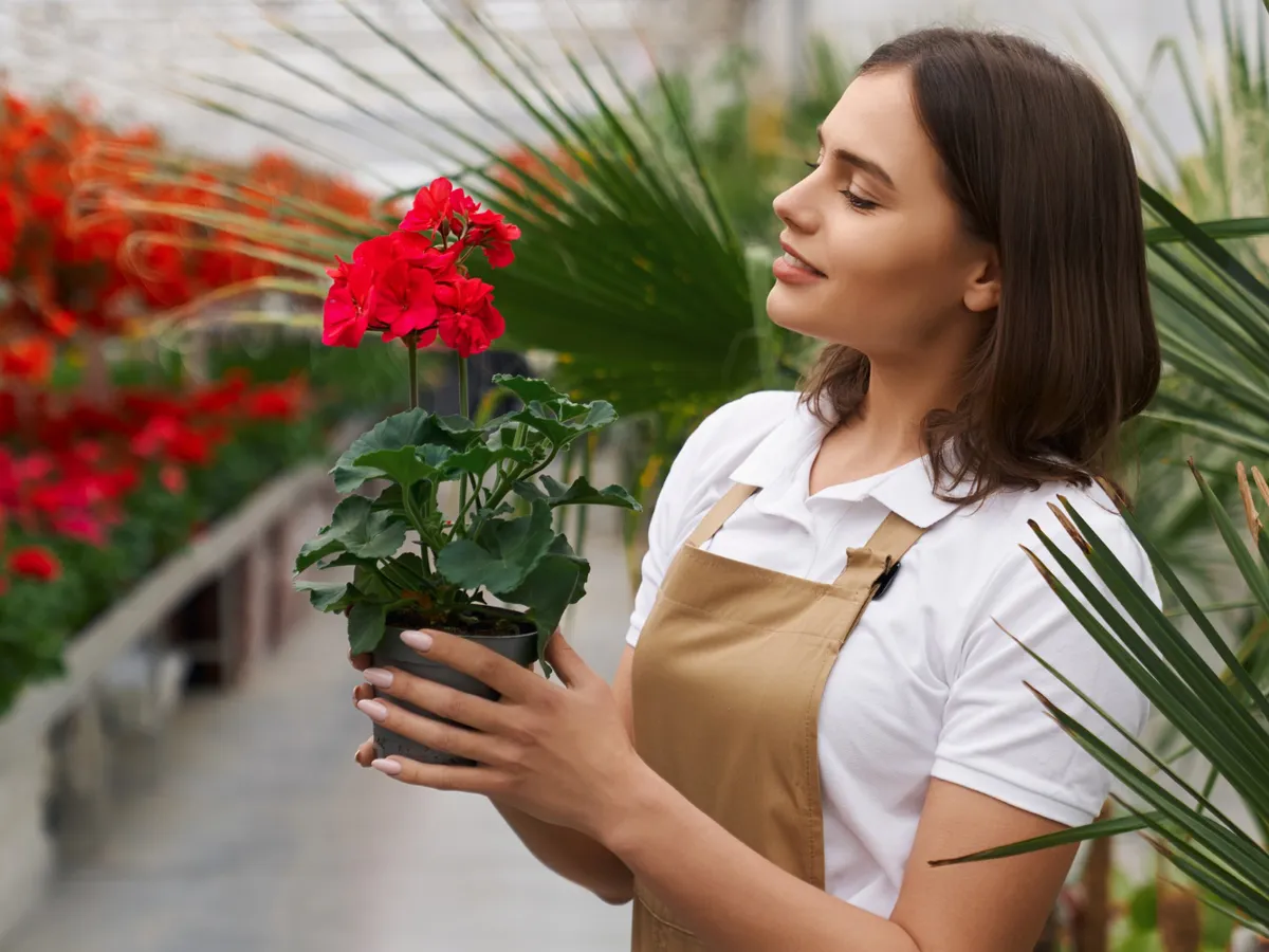 Femeie cu o floare în mână - Foto: Magnific.com (Imagine cu rol ilustrativ)