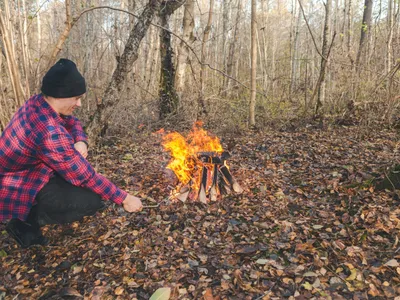 Persoană care face focul cu frunze în pădure - Foto: Freepik (rol ilustrativ)