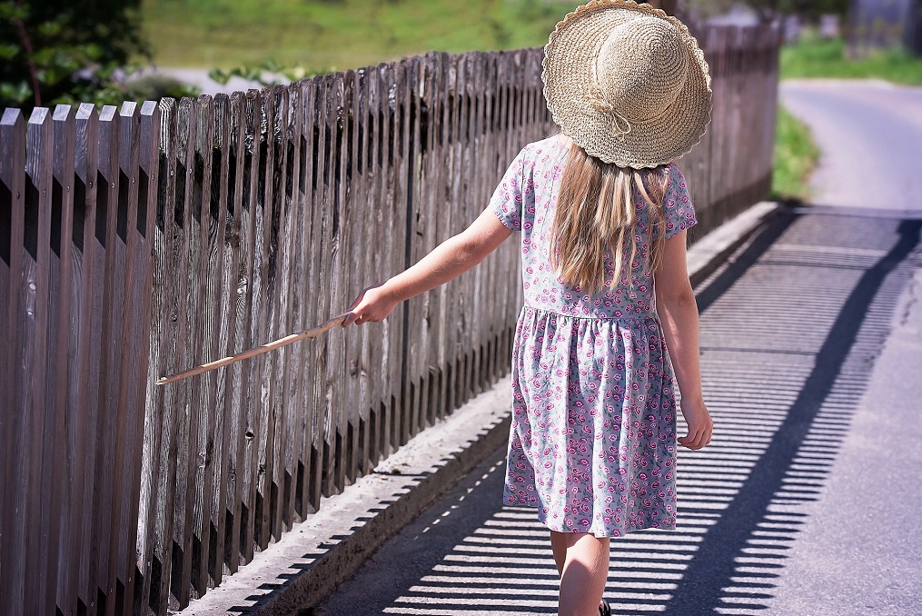 O fetiță se plimbă pe lângă un gard Foto (caracter ilustrativ) Pixabay.com
