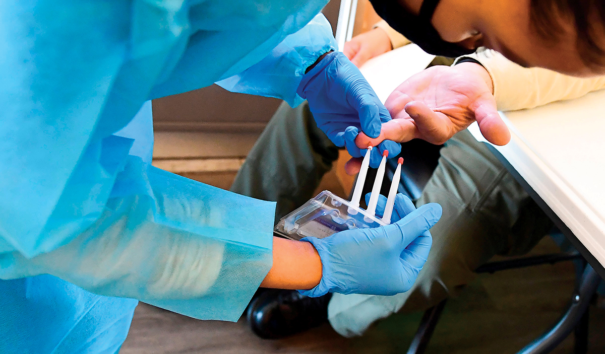 Un asistent medical administrează un test de sânge